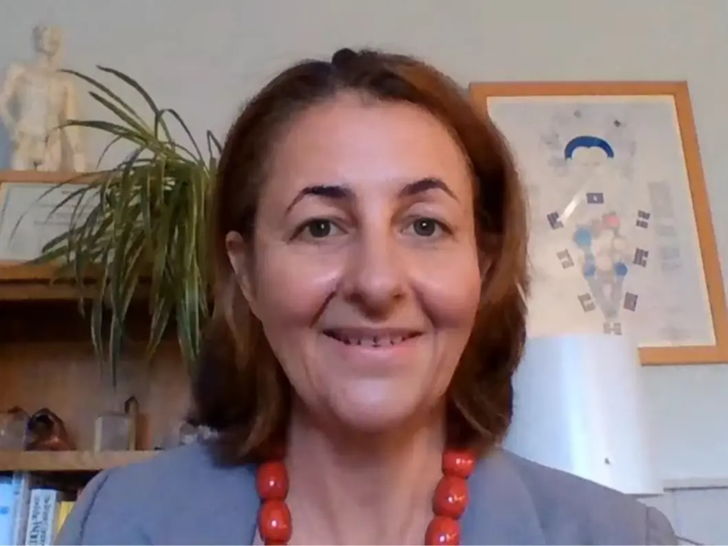 Charmaine Shepherd smiling during an online video consultation in her clinic room